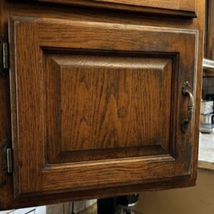 Is Cabinet Refinishing Worth It in Bedford, NH? 1 dark, outdated oak kitchen cabinet
